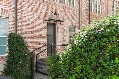 Property entrance featuring brick siding