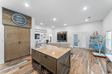 The custom built island offers slide out pot racks