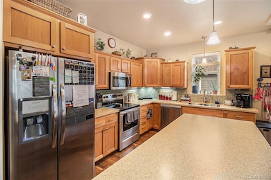 Beautiful kitchen with tons of light, a kitchen island and a pop of color backsplash.