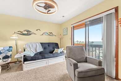 Living room with carpet flooring, ceiling fan, and