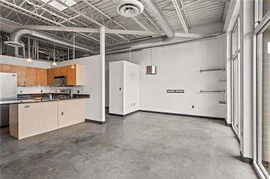 Garage with freestanding refrigerator, baseboards,