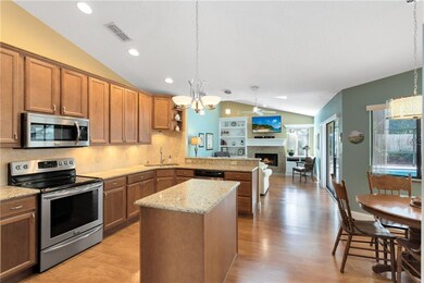 Spacious kitchen with an island & breakfast nook overlooking the family room & pool!