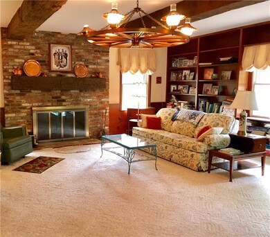 Oversized family room is comfortable with beamed c