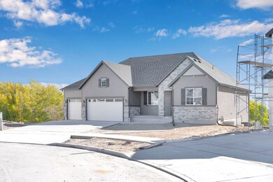 View of front of property with concrete driveway, a garage, stone siding, and a shingled roof