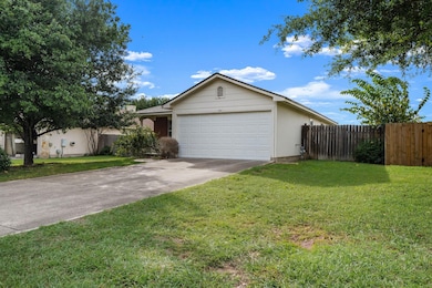Single story home with driveway and a garage