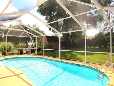 Large Screen Enclosed In-ground Pool With Beautiful Views of Lush Landscaping.