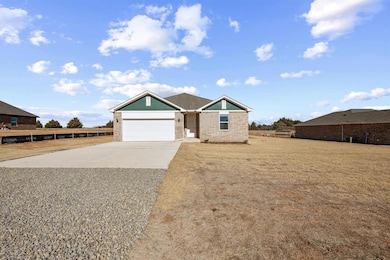 View of front of home with concrete driveway, a ga