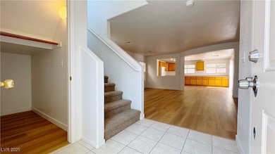 Entryway featuring light wood finished floors and stairs