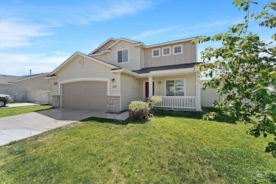 View of front of house with a porch, driveway, an attached garage, and board and batten siding