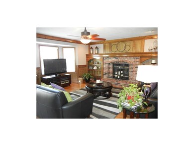 Hardwood and brick fireplace in the family room. V