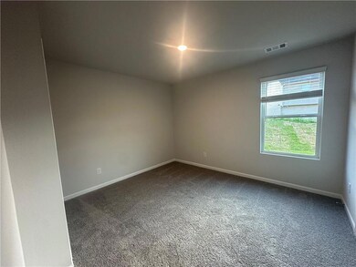 Carpeted spare room with baseboards and visible vents