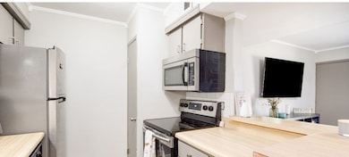 Kitchen with backsplash, appliances with stainless