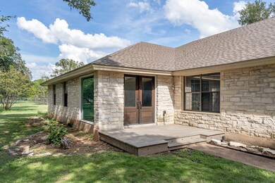 Back of property featuring french doors, stone si