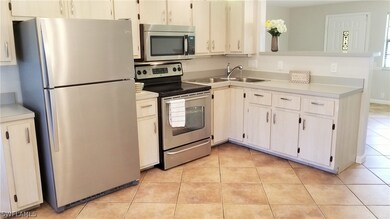 Updated Open Concept Kitchen With Breakfast Bar and View of Pool