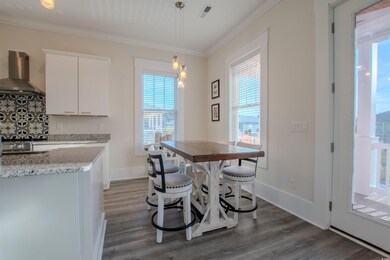 Dining space with dark hardwood / wood-style floor