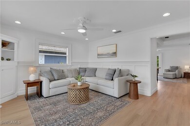 Living area with visible vents, crown molding, and