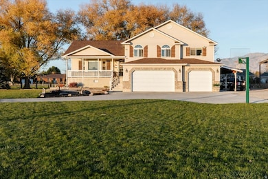 View of front facade with covered porch, driveway, an attached garage, and a front lawn