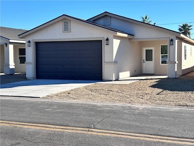 Ranch-style home with concrete driveway, stucco siding, and a garage