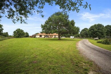 Long sweeping driveway and mature Oak trees shade 