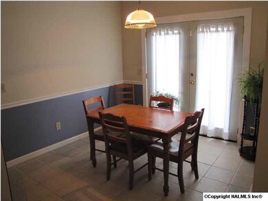 Dining area, tile floor, chair rail and door leading to deck out of dining area.