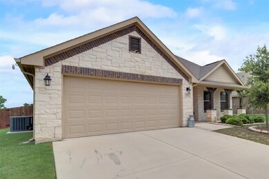 View of front of house with a front yard, a garage