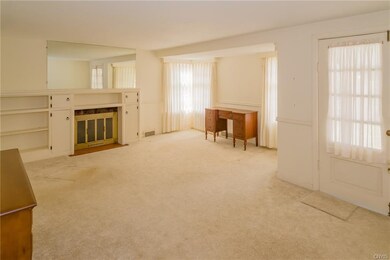 This view shows the stately woodburning fireplace 