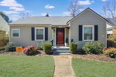 Bungalow with roof with shingles and a front yard