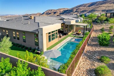 View of pool with a mountain view, a fenced backya