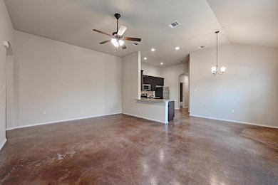 Unfurnished living room featuring finished concre