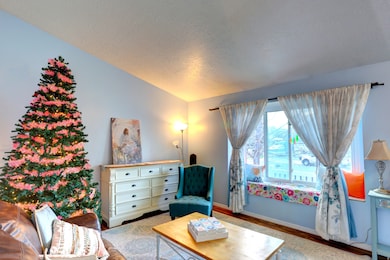 Living area featuring wood finished floors and a textured ceiling