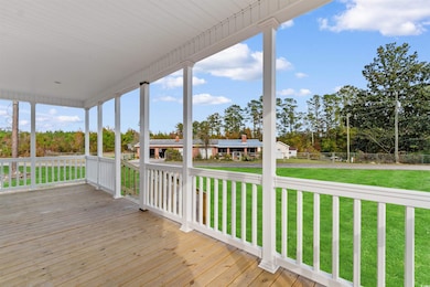 Wooden porch featuring view of wooded area
