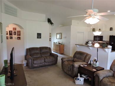 Family room view with vaulted ceilings and upper p