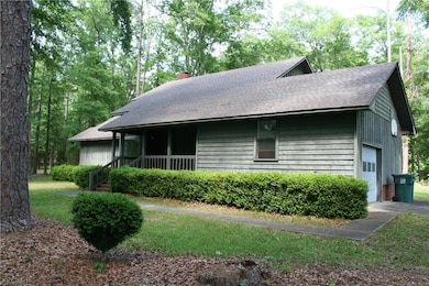 View of side of property with a shingled roof, a c