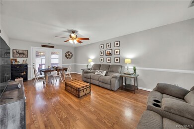 Living room featuring ceiling fan and light hardwo