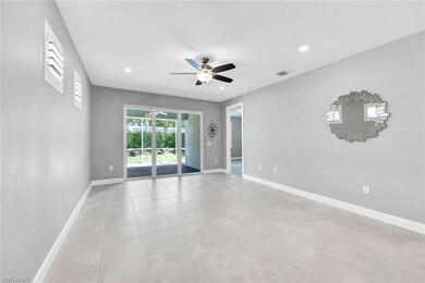 Empty room with ceiling fan and light tile pattern