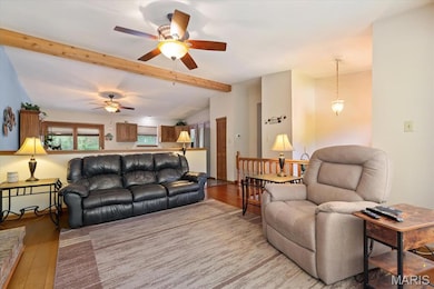 Living room with wood finished floors and ceiling fan