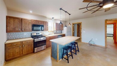 Kitchen with stainless steel appliances, a sink, t