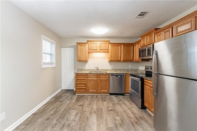 Kitchen featuring light stone countertops, a textu