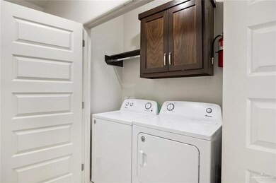 Washroom with cabinets and washing machine and dryer