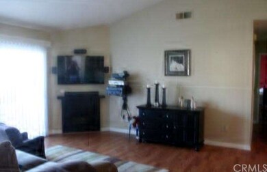 Living room with laminate flooring and cozy firepl