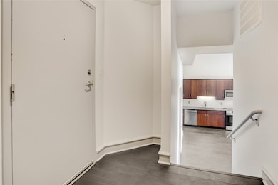 Upon entering, a foyer with coat closet leads towards a few steps, welcoming you home.