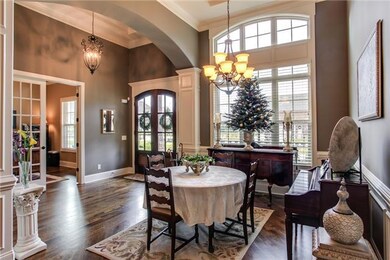 Entertaining is a natural  in this beautiful14x12 diningroom with diagonal sand and finish oak floors, a two story arched window, wainscotting and elegant columns.   Lets not forget the stunning coffered ceiling!