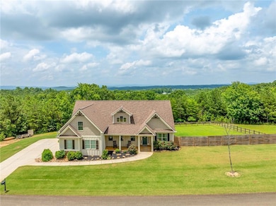 Craftsman inspired home featuring board and batten siding, covered porch, and concrete driveway