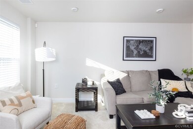 Living room featuring fresh carpet and tasteful pa