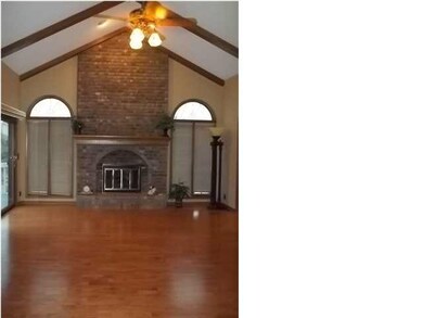 HUGE LIVING ROOM W/ WOOD BEAMS AND BRICK FIREPLACE