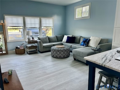 Living room with light wood-style floors and baseboards