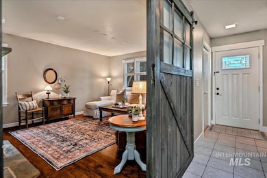 Foyer entrance featuring a barn door and wood finished floors