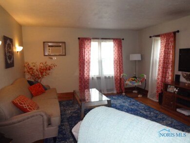 Spacious living room with original hardwood floors