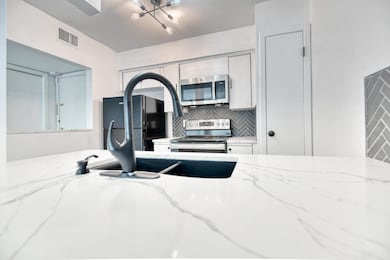 Kitchen with stainless steel appliances, light sto