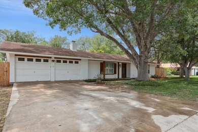 Ranch-style house with an attached garage, brick 